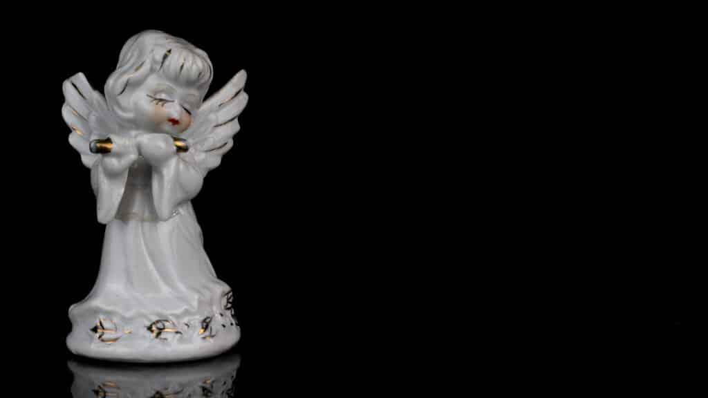 closeup shot of an angel figurine isolated on blac 2023 11 27 04 56 02 utc